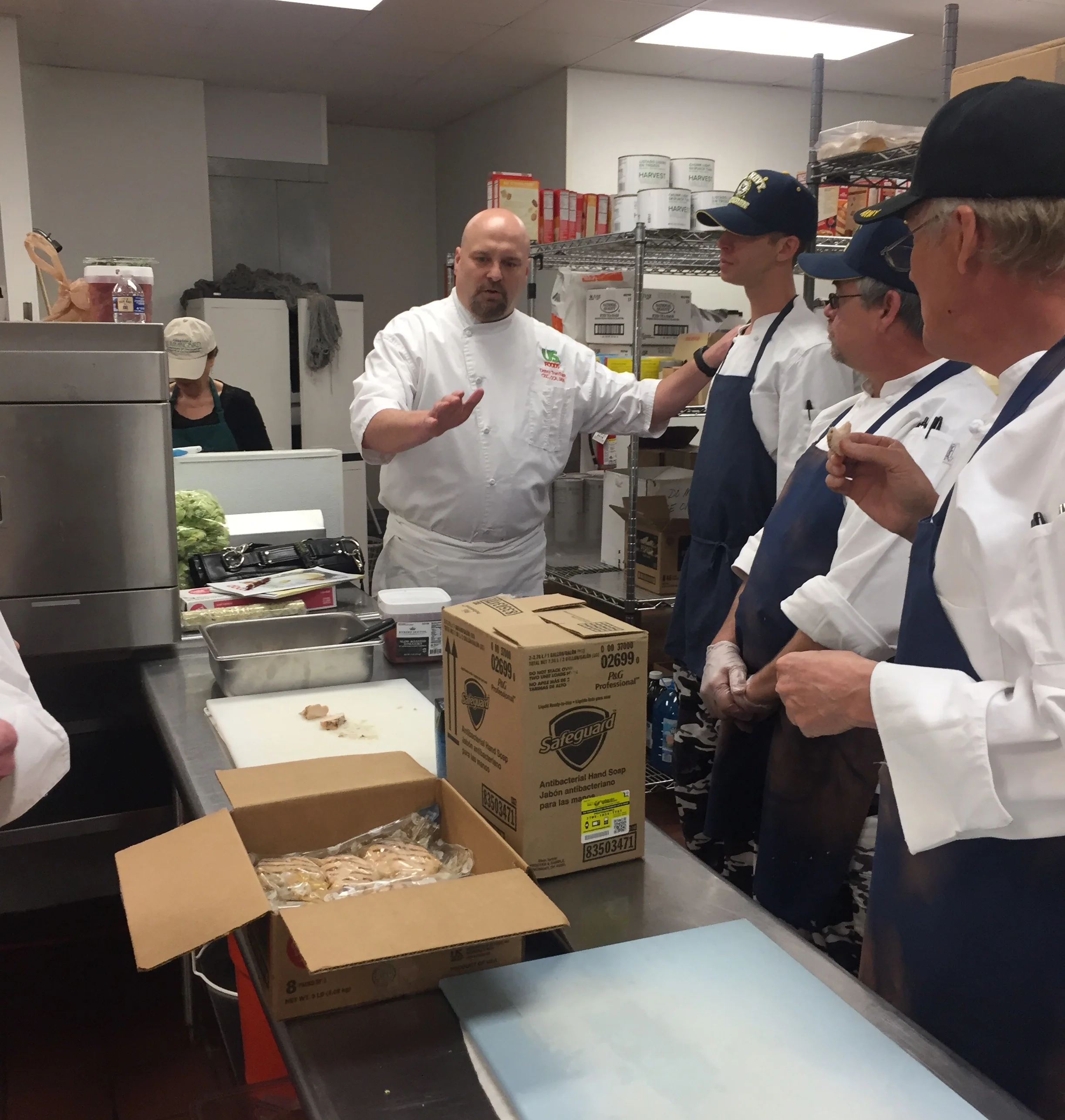 US Foods Chef Denny Trantham works with veterans in ABCCM's culinary program during a recent morning at the Veterans Restoration Quarters. Chef Denny and the students made a delicious lunch from the company's Scoop line of innovative products, and picked up lots of tips and tricks from the chef.