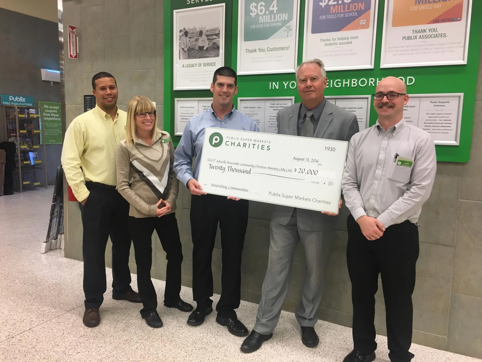 Reverend Scott Rogers, ABCCM's executive director (second from right) accepts a donation from Publix Super Markets Charities along with (left to right) David Yancy, grocery manager; Danielle Meyer, assistant customer service manager; David Jenkins, store manager; and Josh Surles, produce manager.