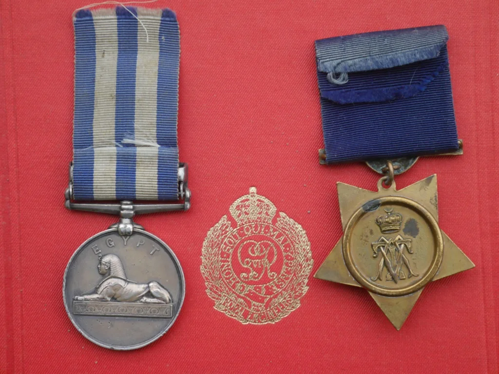 The reverse of the two medals shown above, placed on a copy of the official history of the Royal Engineers in the campaign with the R.E. emblem in between. The first version of the Nile medal, created for the Anglo-French intervention in Egypt in 1882, had that year beneath the Sphinx, but once the decision was made to award the medal for subsequent campaigns the space was left blank and the campaign date put in the clasp instead. The obverse of the Khedive's Star shows his monogram surmounted by a crown.
