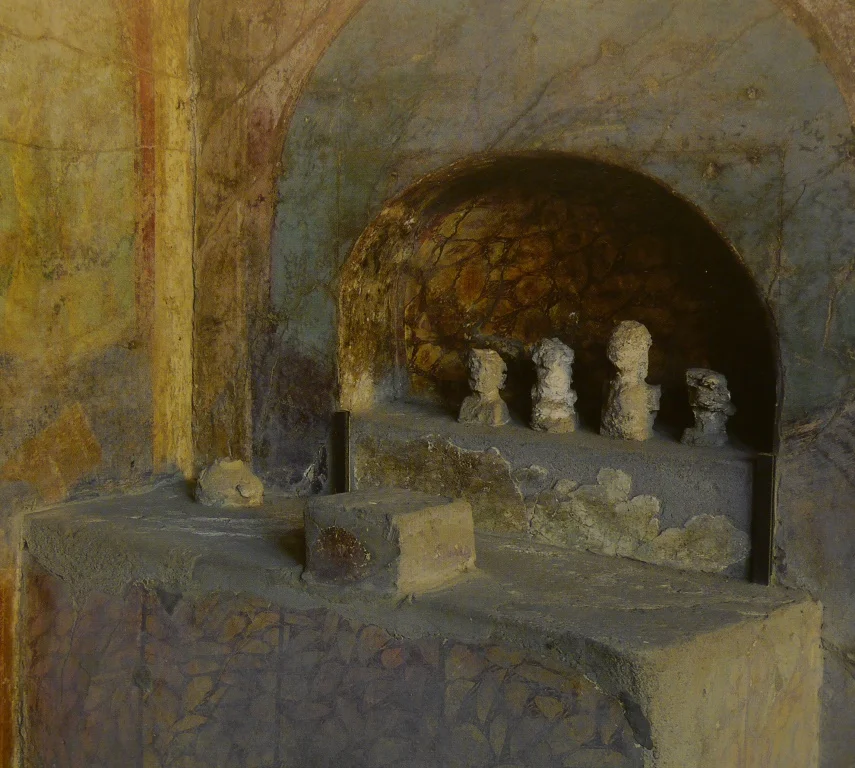 A shrine with crude images of ancestors from the House of the Menander, Pompeii.