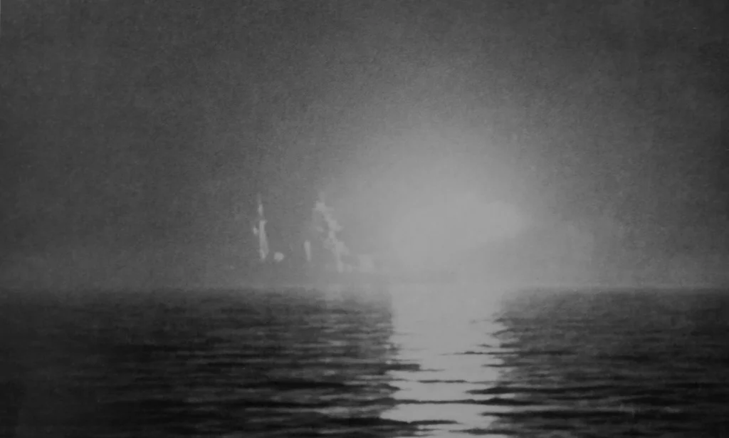 The third monitor, HMS Abercrombie, firing her 15 inch guns in support of the US landings to the west.