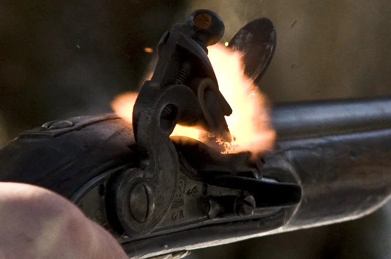 The instant that sparks from the flint ignite the priming powder in the pan. Click to enlarge (photo: Alan Gibbins).
