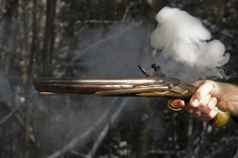 Photo by my brother Alan of me shooting an original Napoleonic period Sea Service pistol of the type depicted in the film Master and Commander . For more images and a video of this pistol, go here .