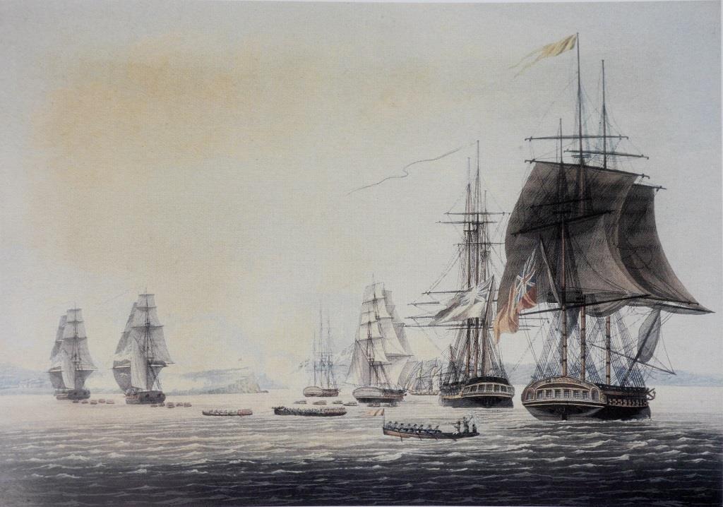 An 1817 aquatint of the British squadron at anchor off Oswego on 6 May 1814, based on a drawing by a Royal Marines officer present at the action, Captain William Steele. The frigate to the right, flying the broad pennant of Commodore Sir James Yeo, is HMS Prince Regent , flagship of the squadron. The boats being rowed ashore are taking Royal Marines, sailors and soldiers to the assault of the fort atop the distinctive jutting promontory, visible amidst the smoke from the bombardment ( National Archives of Canada ).