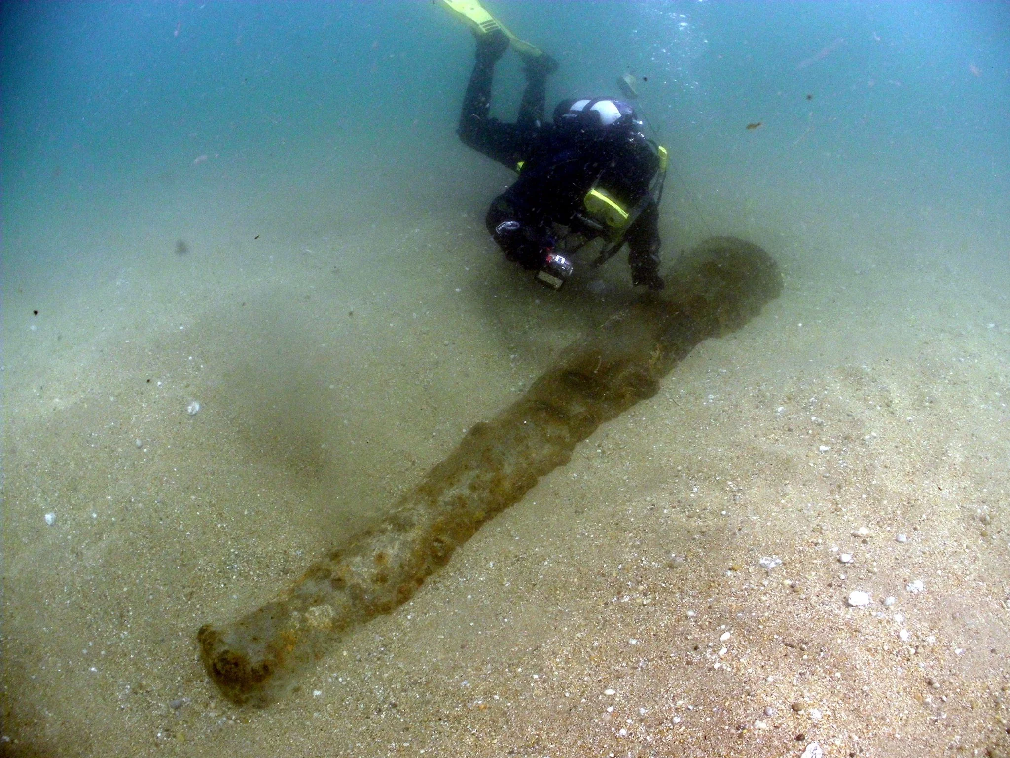 Photo of me on the wreck of HMS Anson in 2018, showing one of the ship’s main armament of 24-pounders - perhaps one of the guns visible in the gunports in Luny’s painting. The wreck lies buried most of the time under deep sand and over many visits we have only ever seen this one gun. Several 24-pounders were salvaged from the site between the late 19th century and the 1960s, including two now mounted on gun carriages at the nearby port of Porthleven, one outside the museum in Helston and two outside the west entrance to RNAS Culdrose nearby (photo: Mark Milburn)..