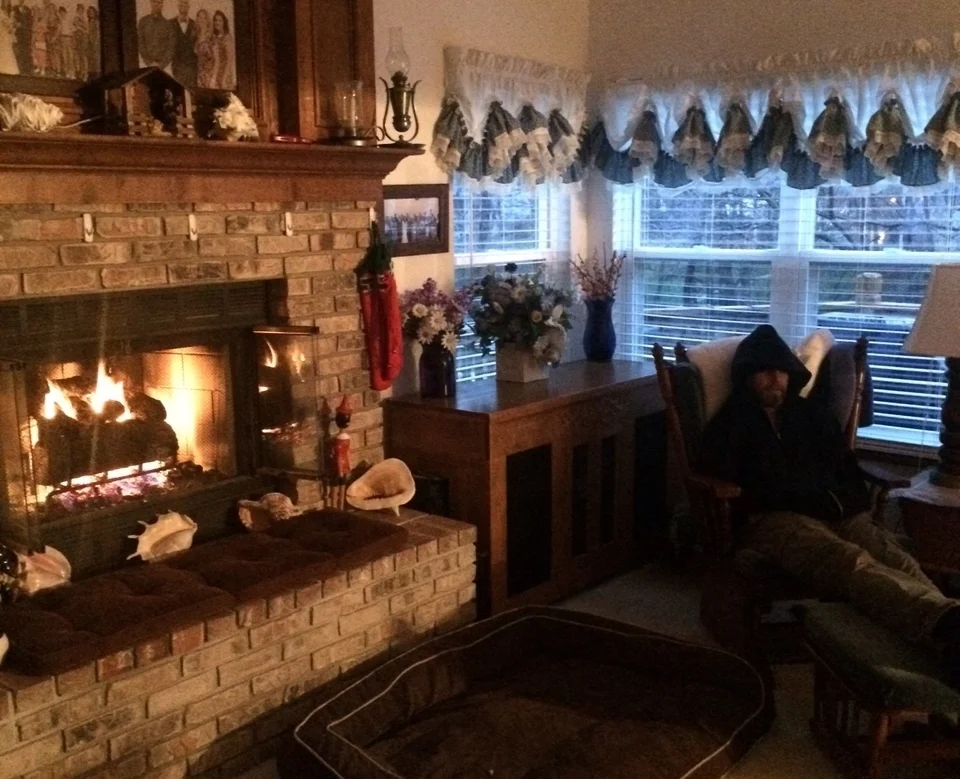 Steve in a cinnamon roll carb coma, next to the fireplace.
