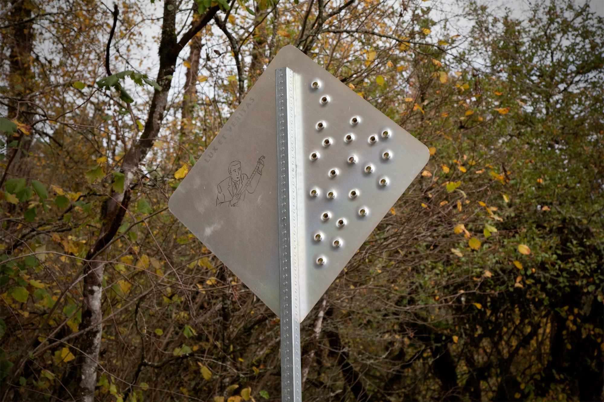 Back-of-Sign-with-Bullet-Holes-and-Photographer.jpg