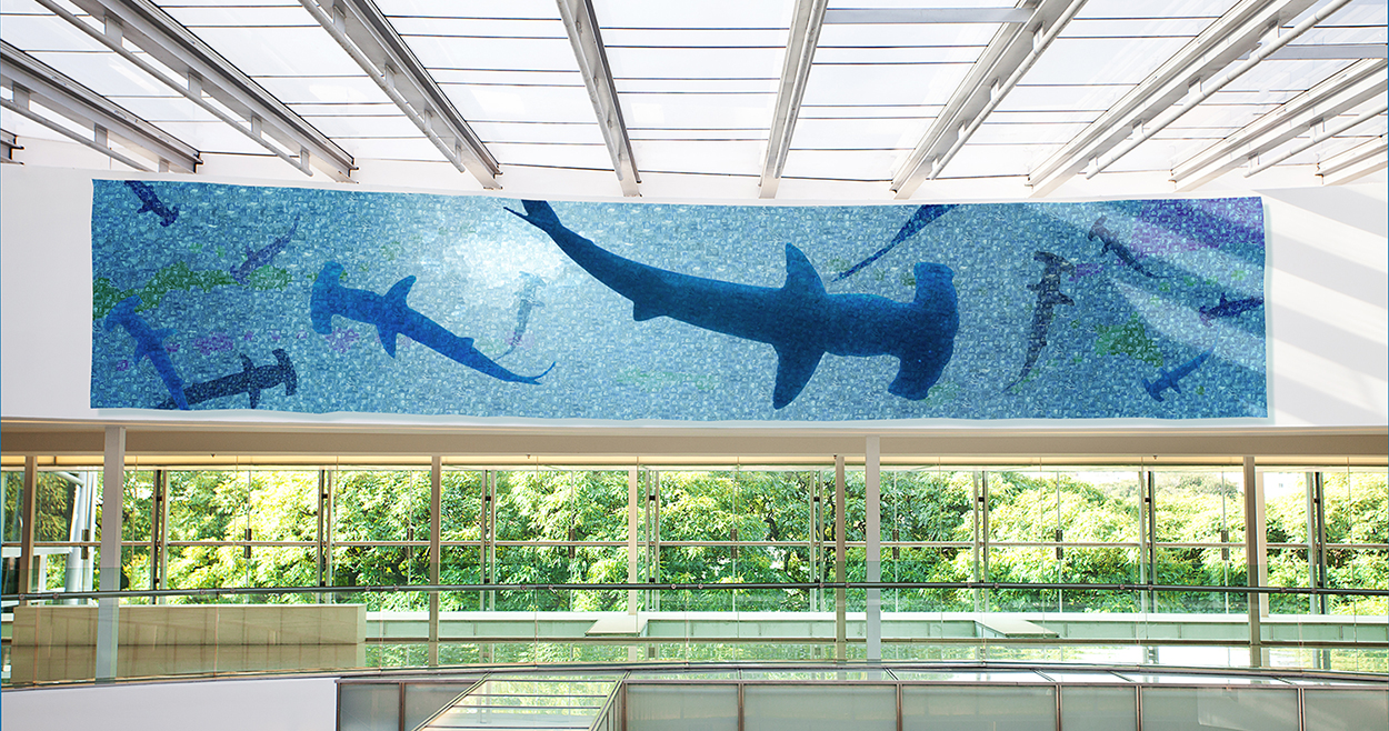 "Hammerhead" 309 L x 59" H x 2" D, postage stamps on aluminum CLIENT: Cyber security company THEIR STORY: Always under attack. Always vigilant. ART INSPIRATION: I wanted to give the feeling of always being under threat.