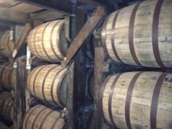Bourbon aging in white oak barrels, growing ever more delicious