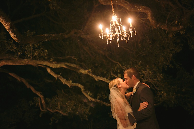 052413-17-no-slide-bride-groom-kiss-under-chandelier.jpg