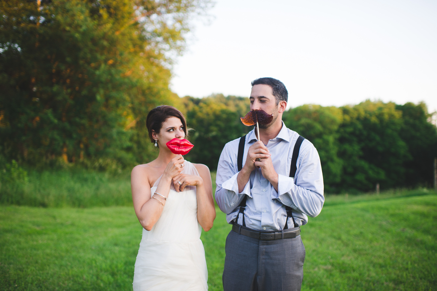 The cutest photo props - big red lips and a mustache for the bride and groom | photo by Jessica Oh Photography