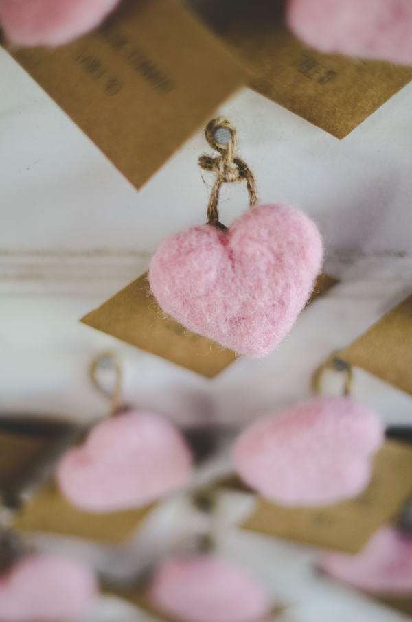 felted pink hearts on escort cards | photo by Jessica Oh Photography #escortcards #pinkhearts