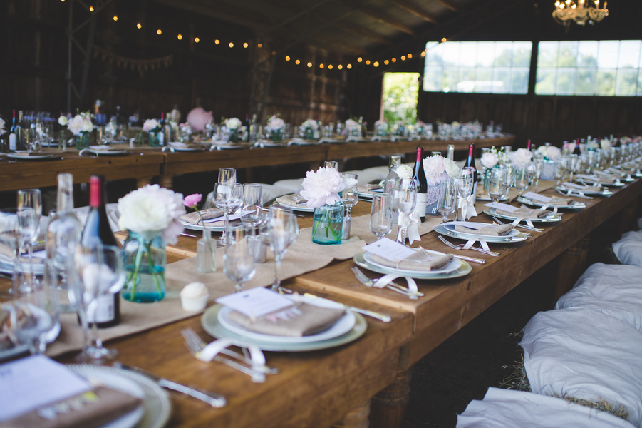 Elegant tablesetting for a barn wedding | photo by Jessica Oh Photography #haybaleseats #longreceptiontables