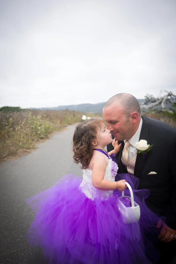 The groom and the cutest flower girl in a purple tutu | photo by Portrait Design by Shanti #flowergirl #purple #tutuflowergirldress #flowergirltutu