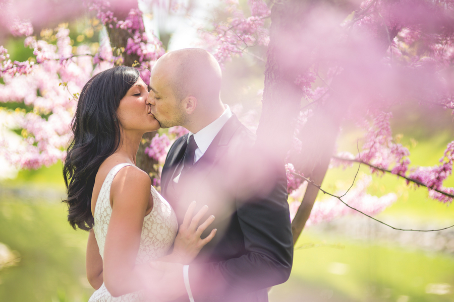  Spring Engagement Session with a couple kissing amongst the pink tree blossoms | photo by Style and Story Creative 