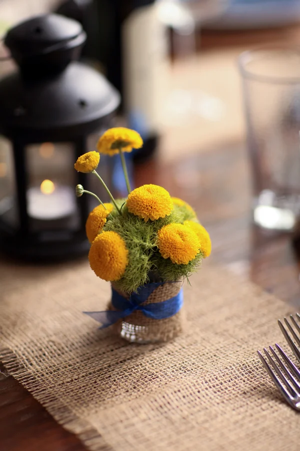 cute little yellow mini floral arrangement wrapped in burlap and tied with blue ribbon | Pepper Nix Photography