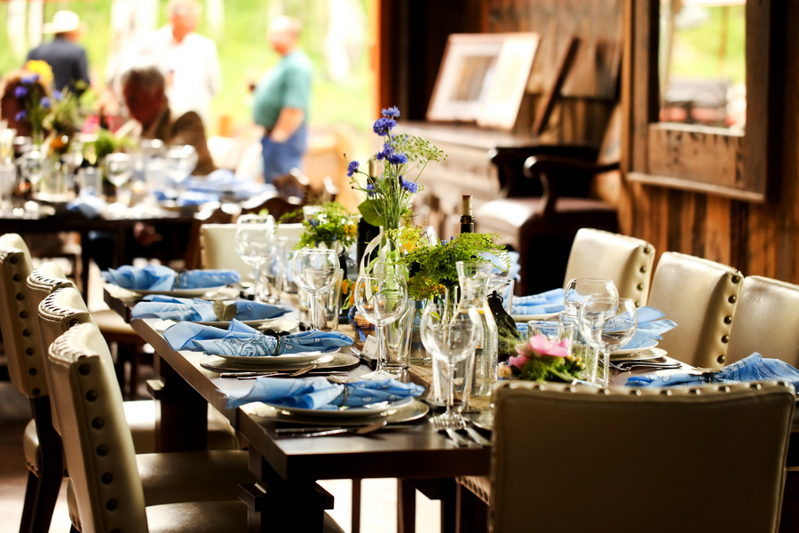  wedding reception with&nbsp;wooden ranch tables and wildflower centerpieces | Pepper Nix Photography 