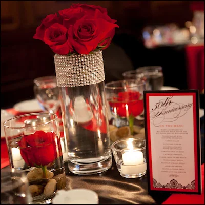 gorgeous red roses in glass vase with a ribbon of bling via Madeline's Weddings and Events in Canada on Brenda's Wedding Blog Vendor Guide www.brendasweddingblog.com