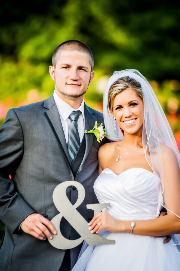  Bride and Groom holding ampersand sign | photo by Ross Costanza Photography | as seen on www.BrendasWeddingBlog.com 