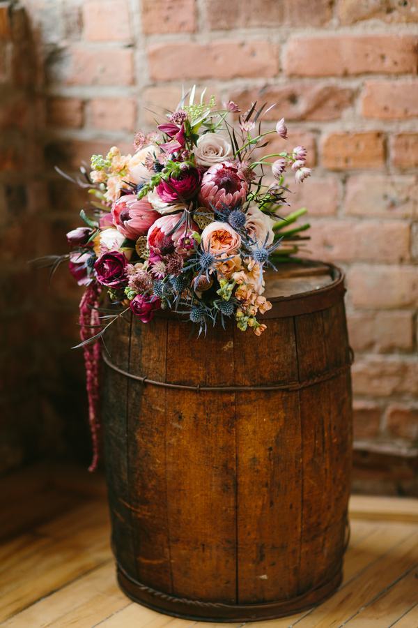  Lush Wedding Bouquet in deep tones of burgundy with accents of pink, peach, champagne, blue + lavender / from Wallflower Designs / photo by Maggie Fortson Photography 