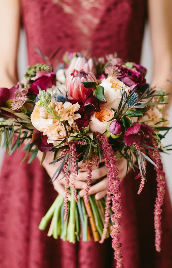 Gorgeous Wedding Bouquet with protea, ranunculus, blue thistle and lotus pods / by Wallflower Designs / photo by Maggie Fortson Photography