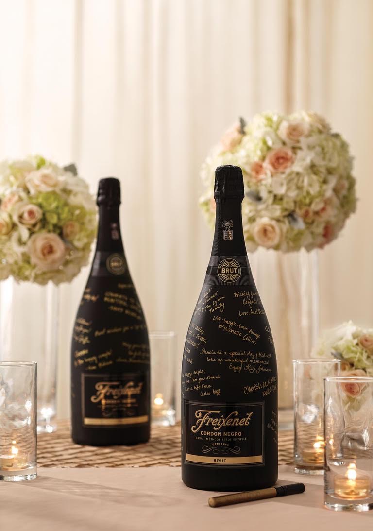 Surprise your guests with a unique guestbook to sign by using a magnum of Freixenet Brut and a gold pen for signing