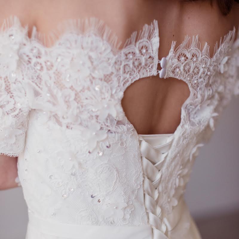  Romance is in the air with this lovely off the shoulder Lyra Vega wedding gown. Embellished with beading and lace appliques, this vintage inspired beauty is finished with scalloped lace trim at the hem and neckline. Perfectly delicate and luxurious 