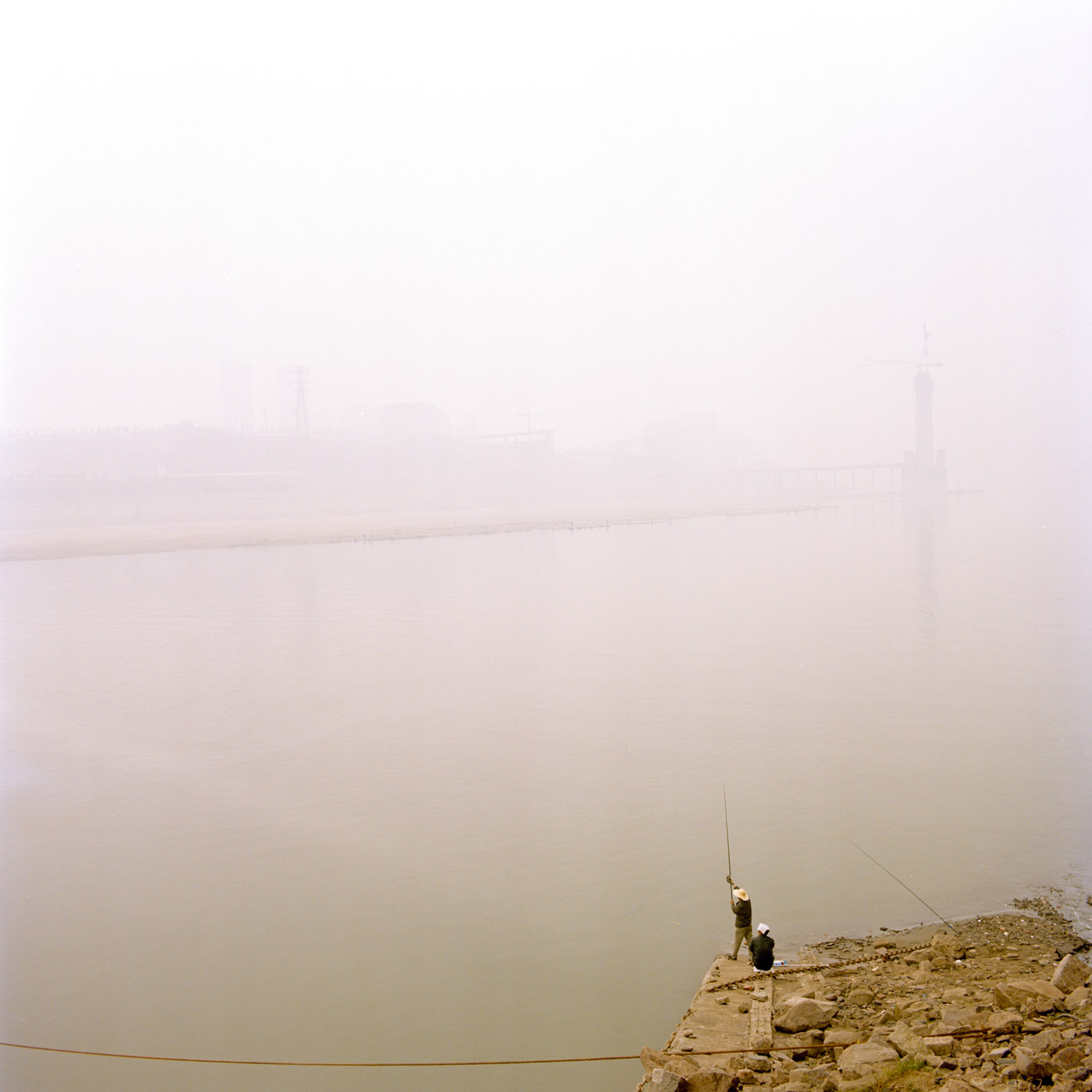  Local people fishing on the Jialing river downtown Chongqing. The polustion dust is so strong that we cant see any side of the city 