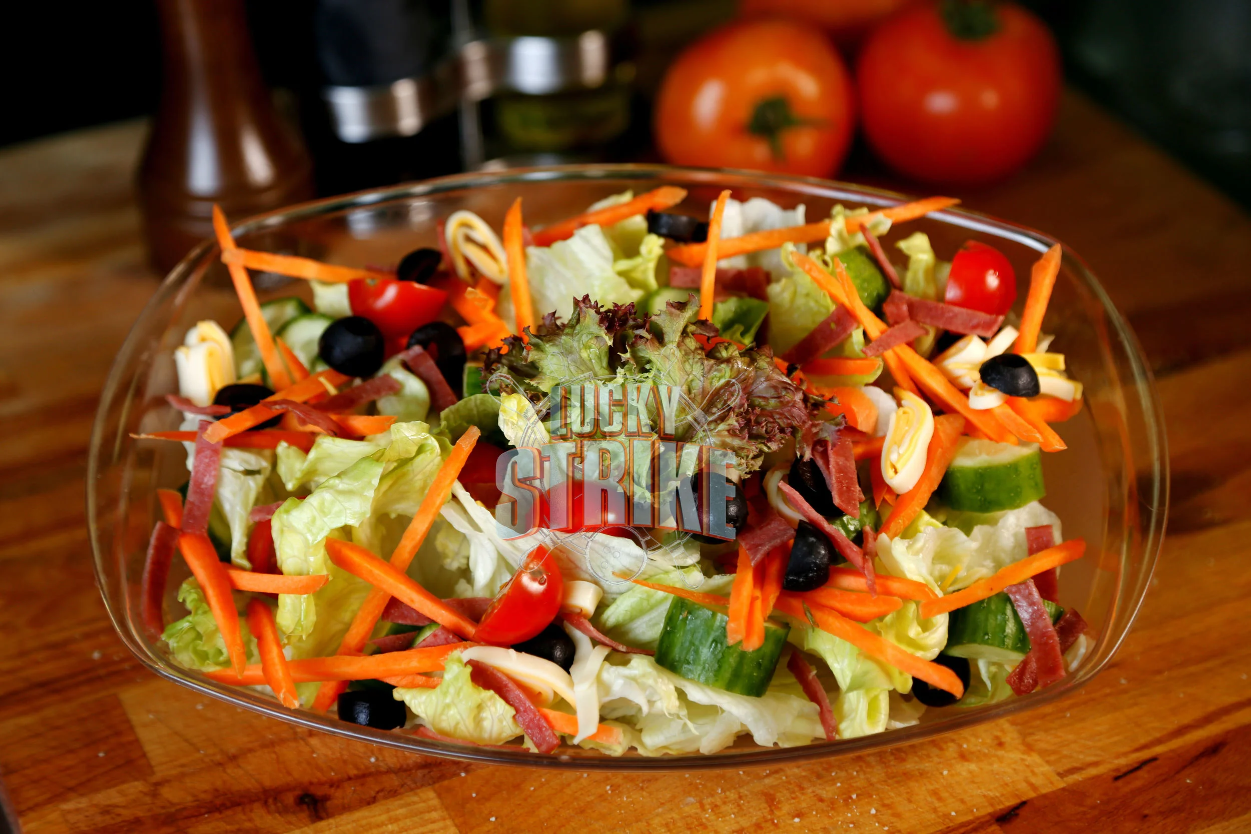 CHEF SALAD 25 A layered mix of freshly tossed romaine lettuce, mozzarella cheese, carrots, sliced olives, bacon, cucumber & red onion