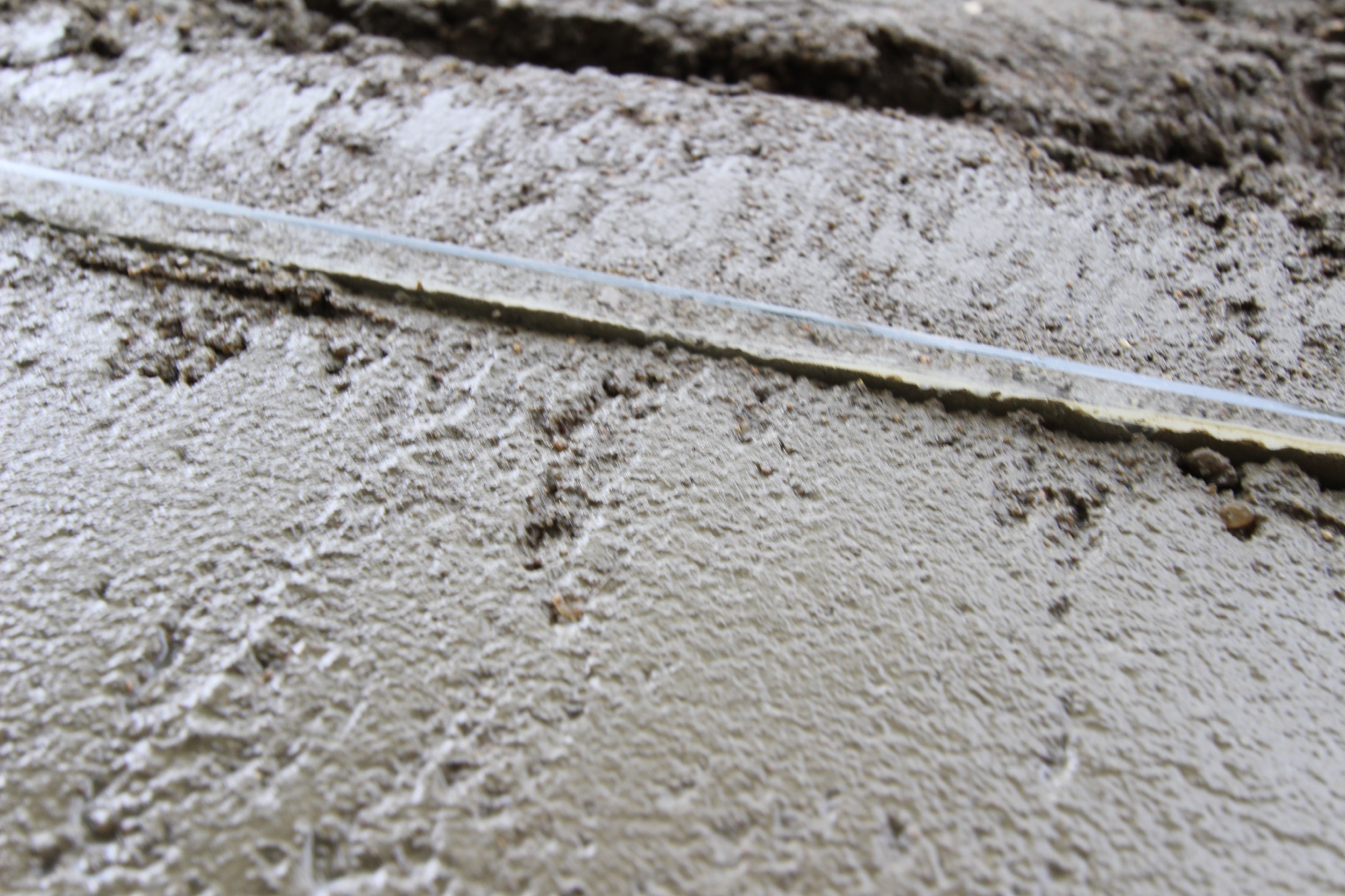 It gets laid directly into the concrete underlay. The terrazzo will then be poured and everything sanded smooth.