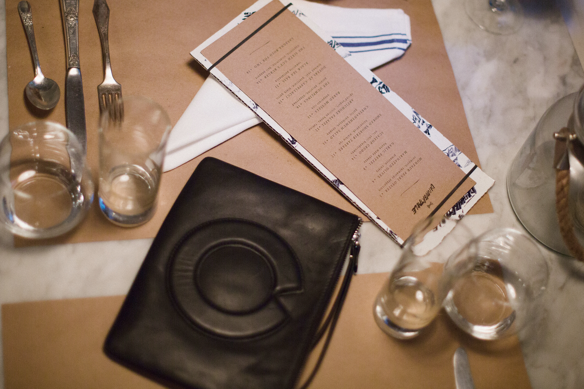 OVERT clutch at dinnertable by Den Hospitality