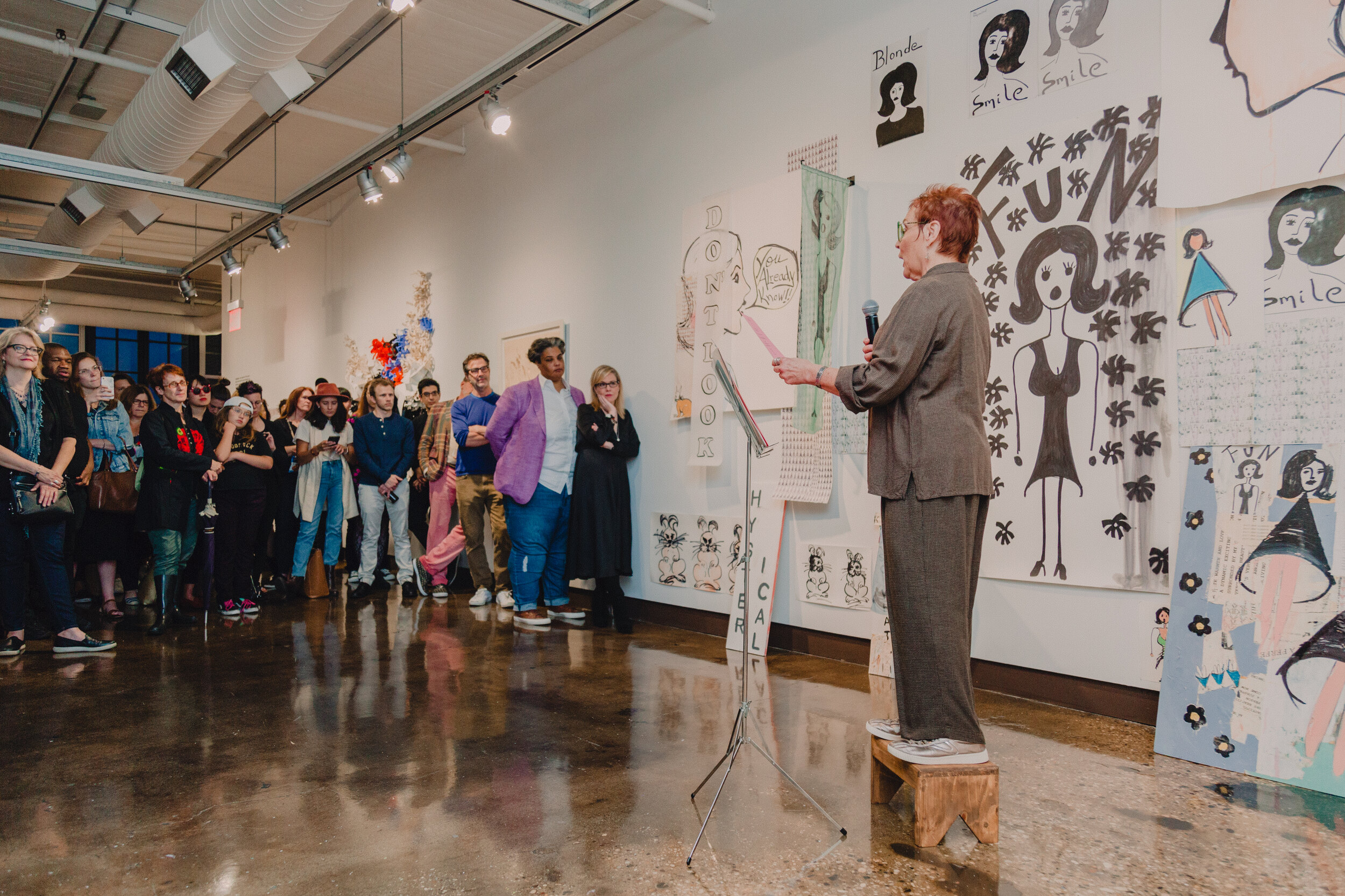 Pamela Butler performs in front of her installation