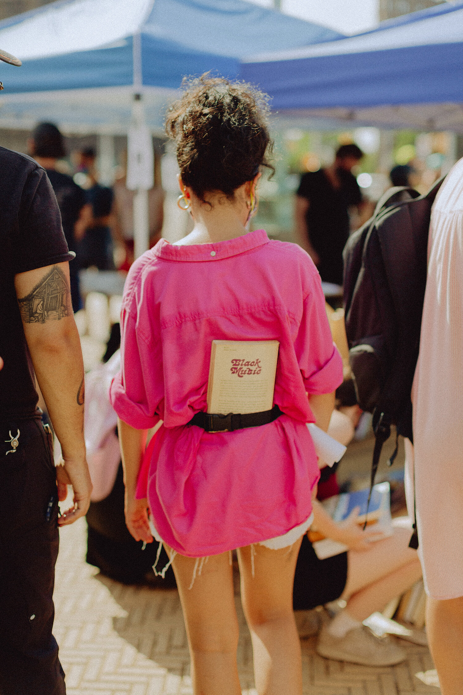 Volunteer with "Black Music" book tucked into fanny pack