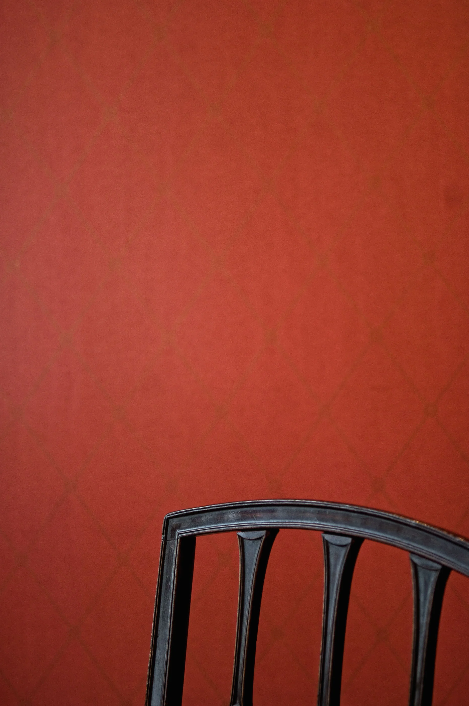 Red Wall / Black Chair