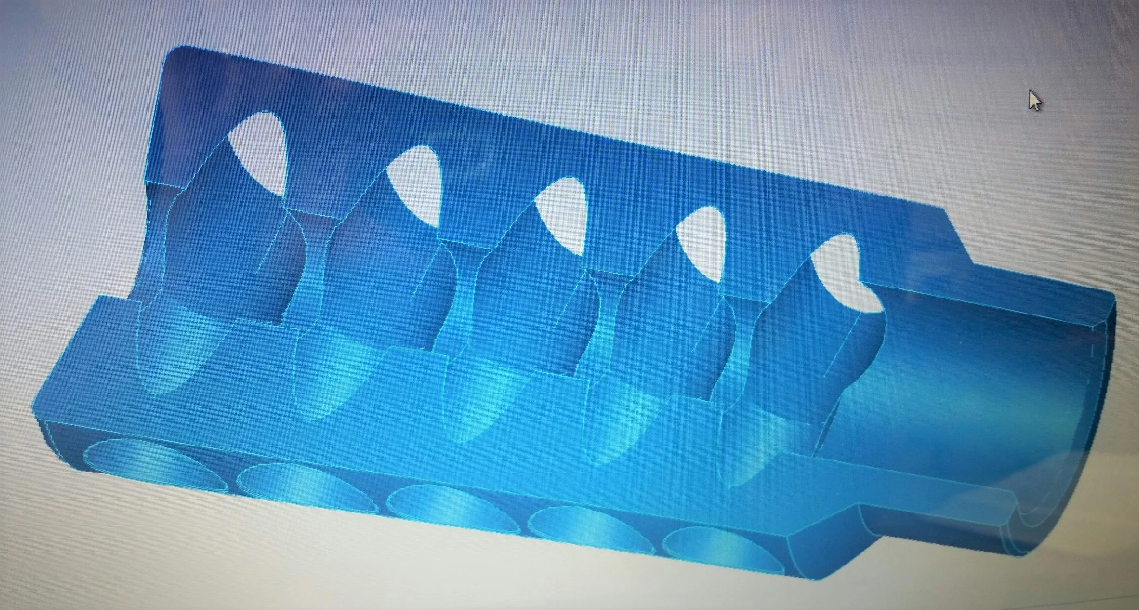 Linear Cross-Section displaying width of expansion chambers created by intersection of port holes. Unique design creates large surface areas while minimizing weight.
