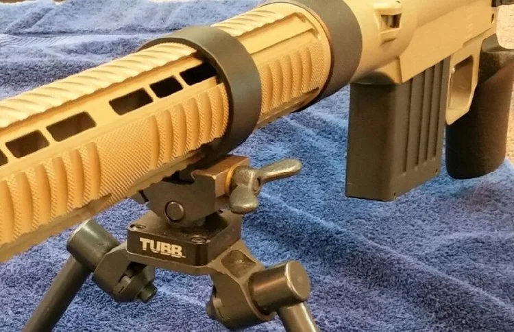 Seen assembled are the new Tubb Non-symmetrical Bi-pod and “Speed Ring”. The “Speed Ring” providing fast and versatile relocation of the bi-pod along the forend tube. Both are standard on the Tubb Adaptive Target Rifles.