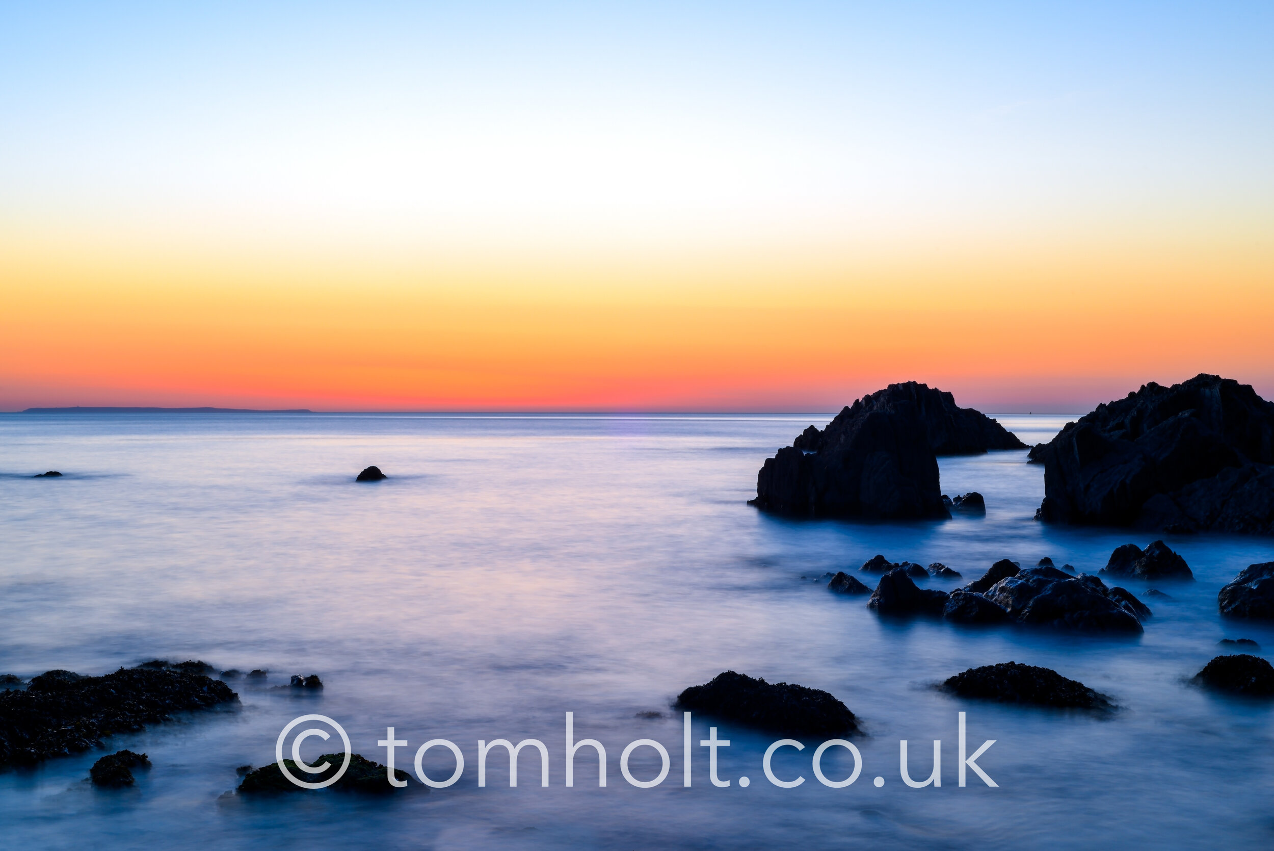 Beautiful calm sea and sunset scenery on the ocean as light refl