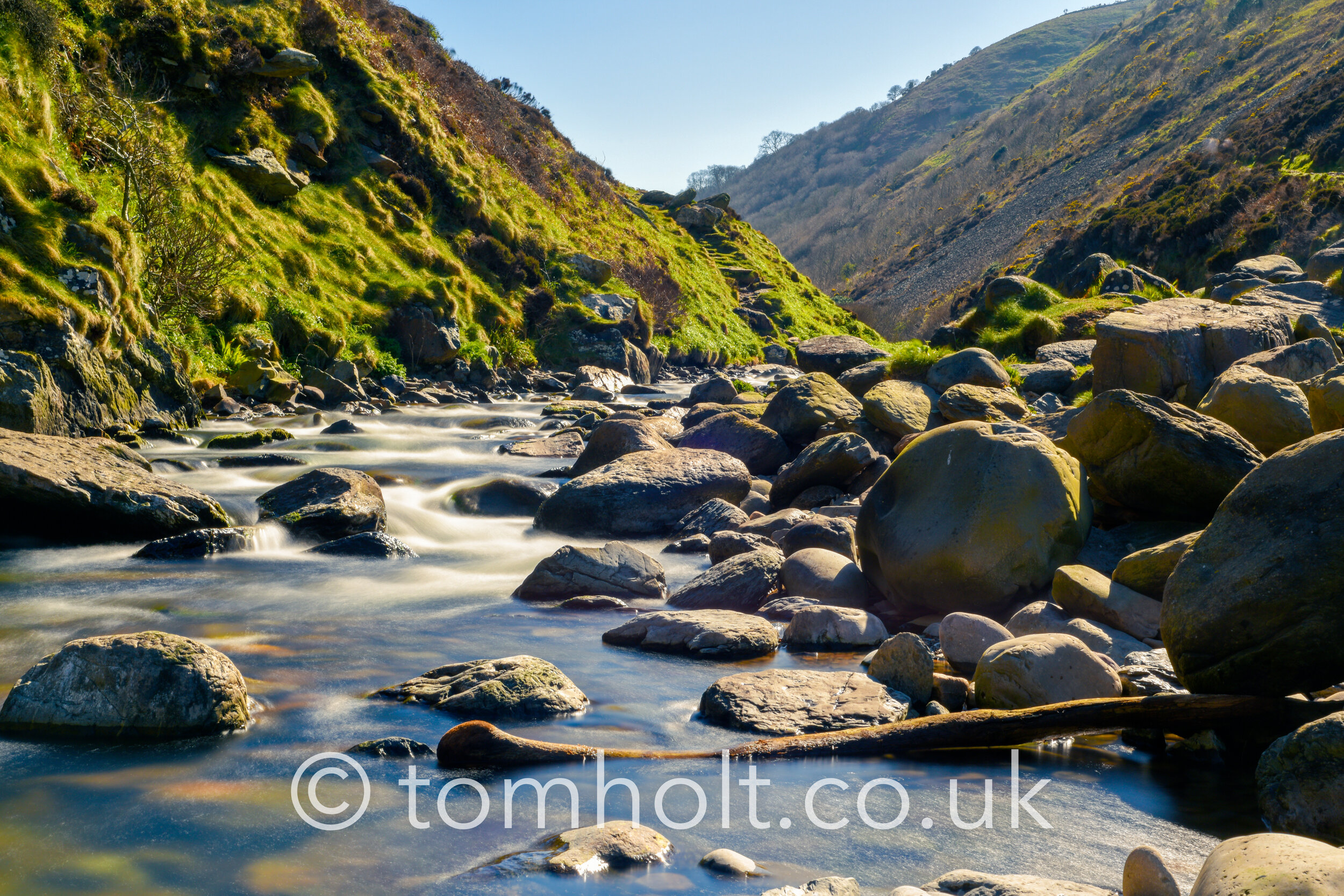 Rushing river water over rocks and boulders in a scenic countrys
