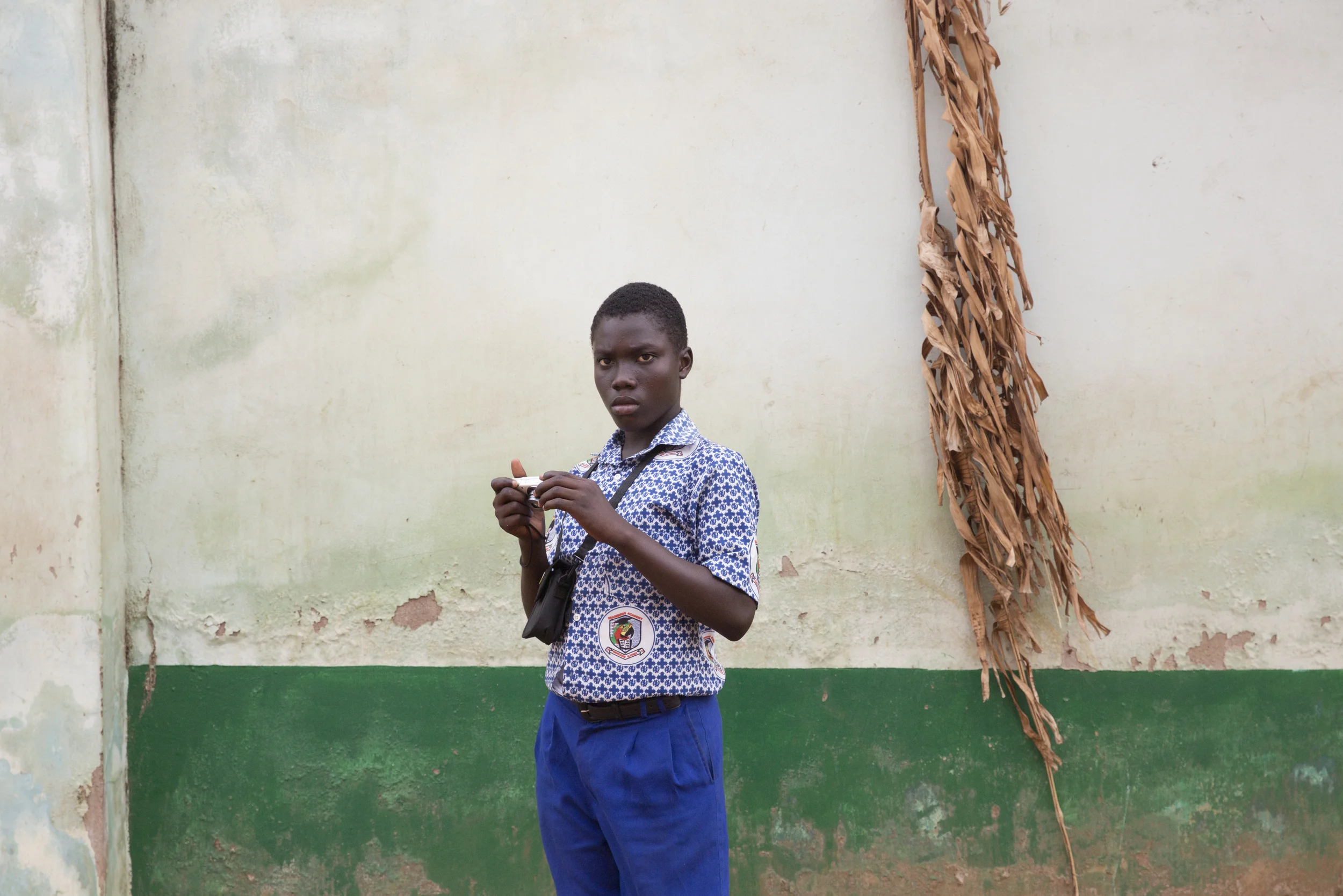 Emmanuel stops to review his work (after he saw me taking pictures of him, he proceeded to take pictures of me. He loved the idea of a "candid camera"). 
