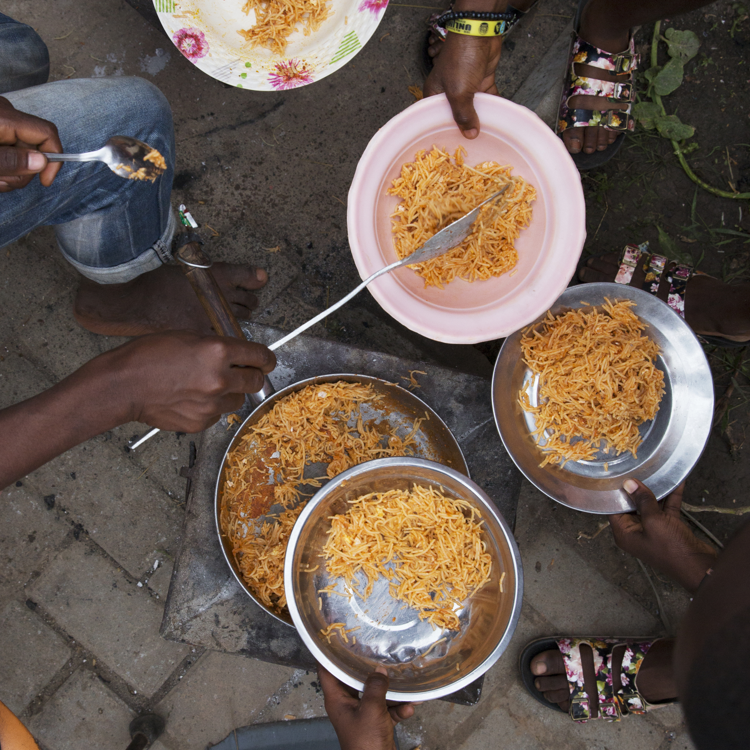 Precious dolls out "jollof spaghetti" to the other boarding students.
