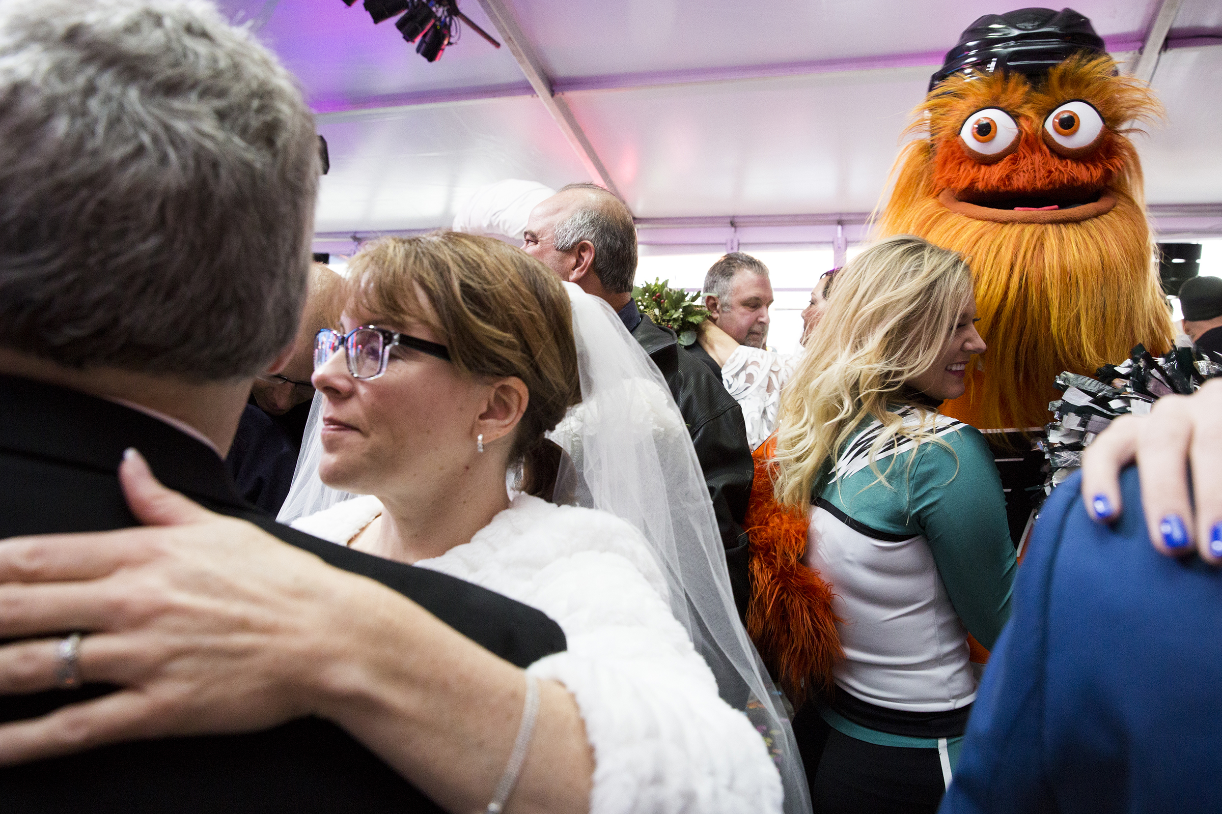Gritty (right), the beloved mascot of the Philadelphia Flyers hockey team, ordains a mass wedding of over sixty couples at the Preston and Steve Show’s Camp Out For Hunger on November 28, 2018. (On assignment for Chorus Media Group)