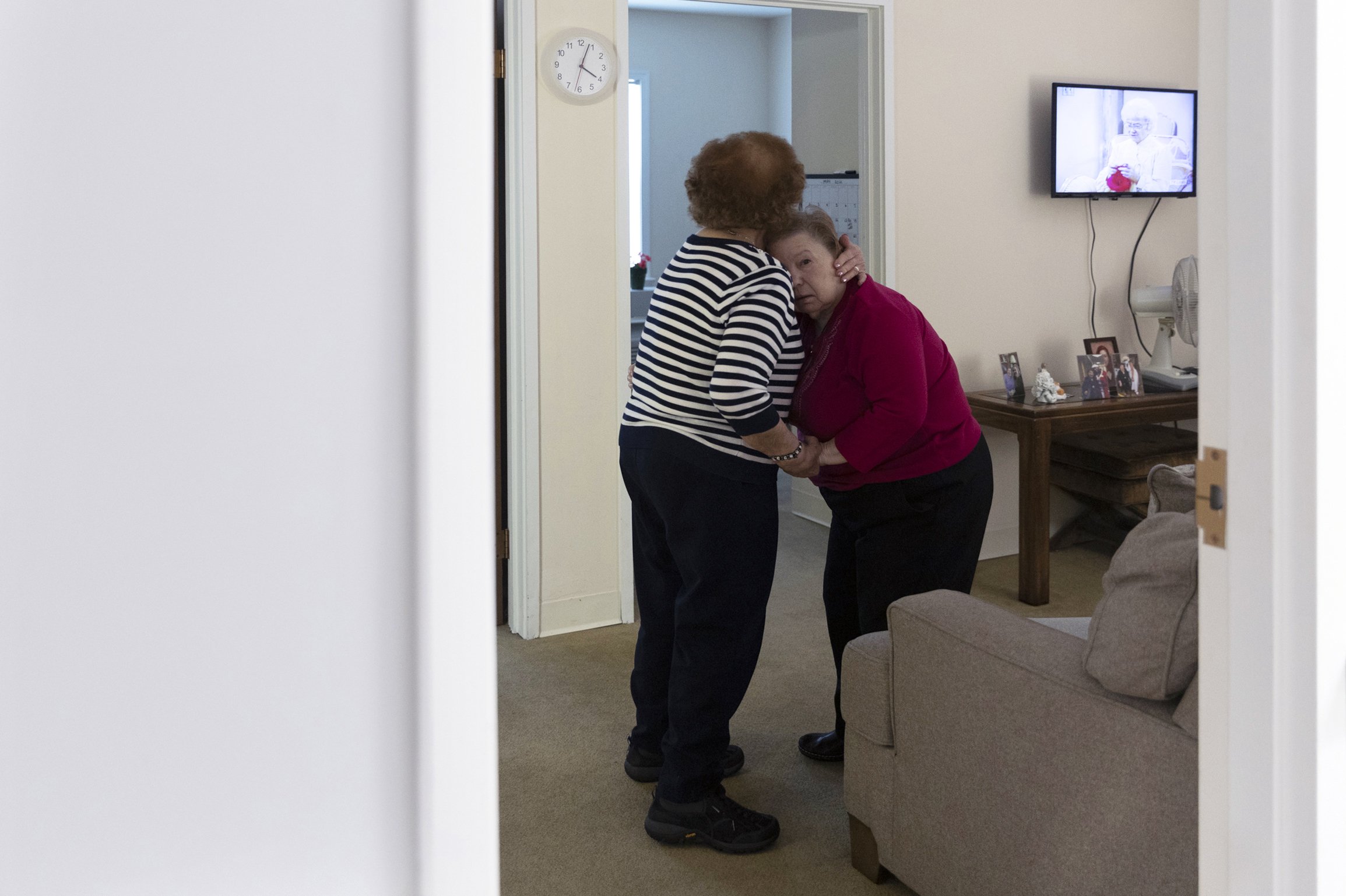  Pauline (left) comforts MaryAnn on May 23, 2021. MaryAnn’s dementia has been greatly worsened due to the social isolation necessitated by the pandemic.  