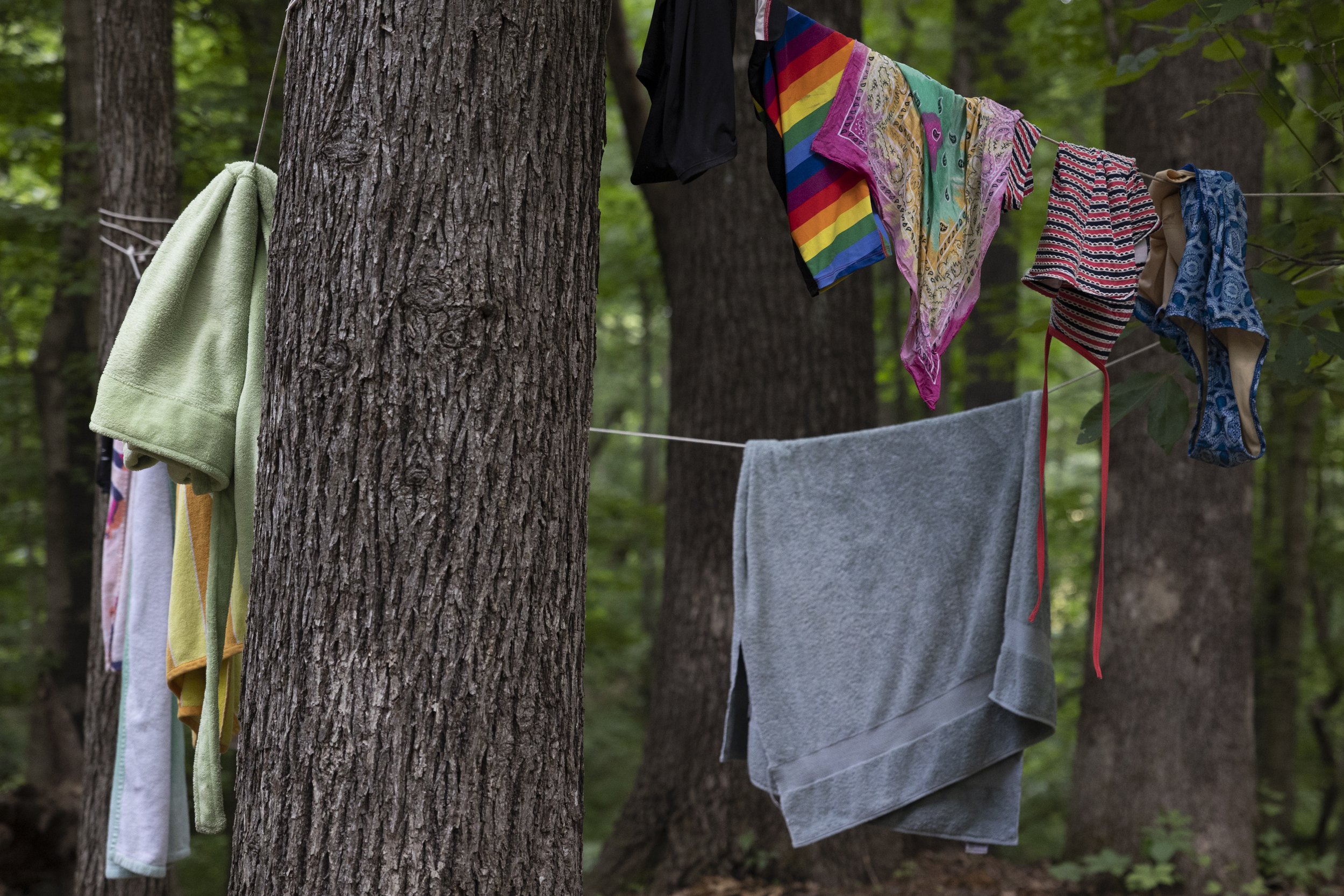  Wet bathing suits and towels are strung up to dry at the middle school bunks. 