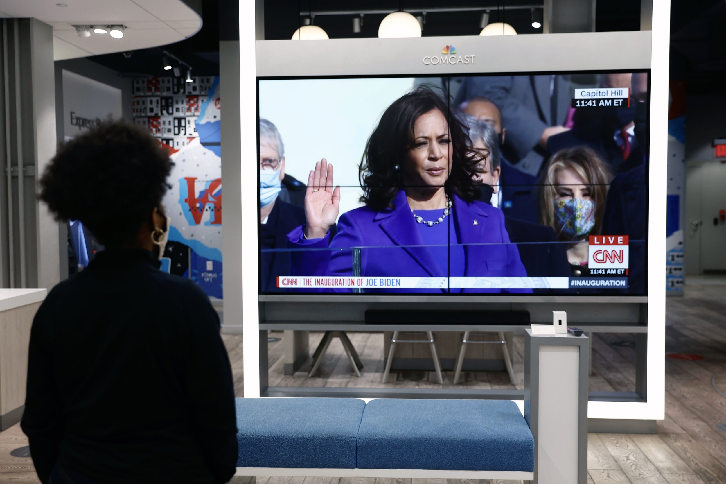  A store employee watches the inauguration of the first female and first African American Vice President of the United States, Kamala Harris, in Philadelphia, Pennsylvania on January 20, 2021. (On assignment for Reuters) 