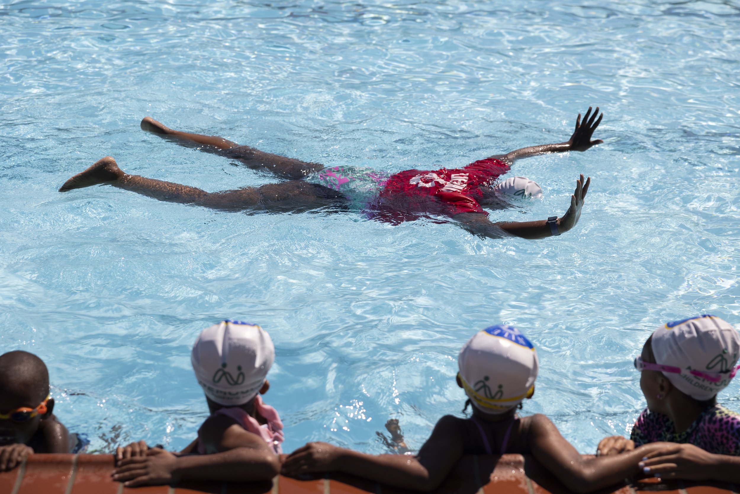 Lifeguard and swim instructor Tujuanna Jackson teaches children how to float and hold their breath under water at the free “No Child Will Drown In Our Town” program offered by Nile Swim Club in Yeadon, Pennsylvania on June 29, 2022. (On assignment f