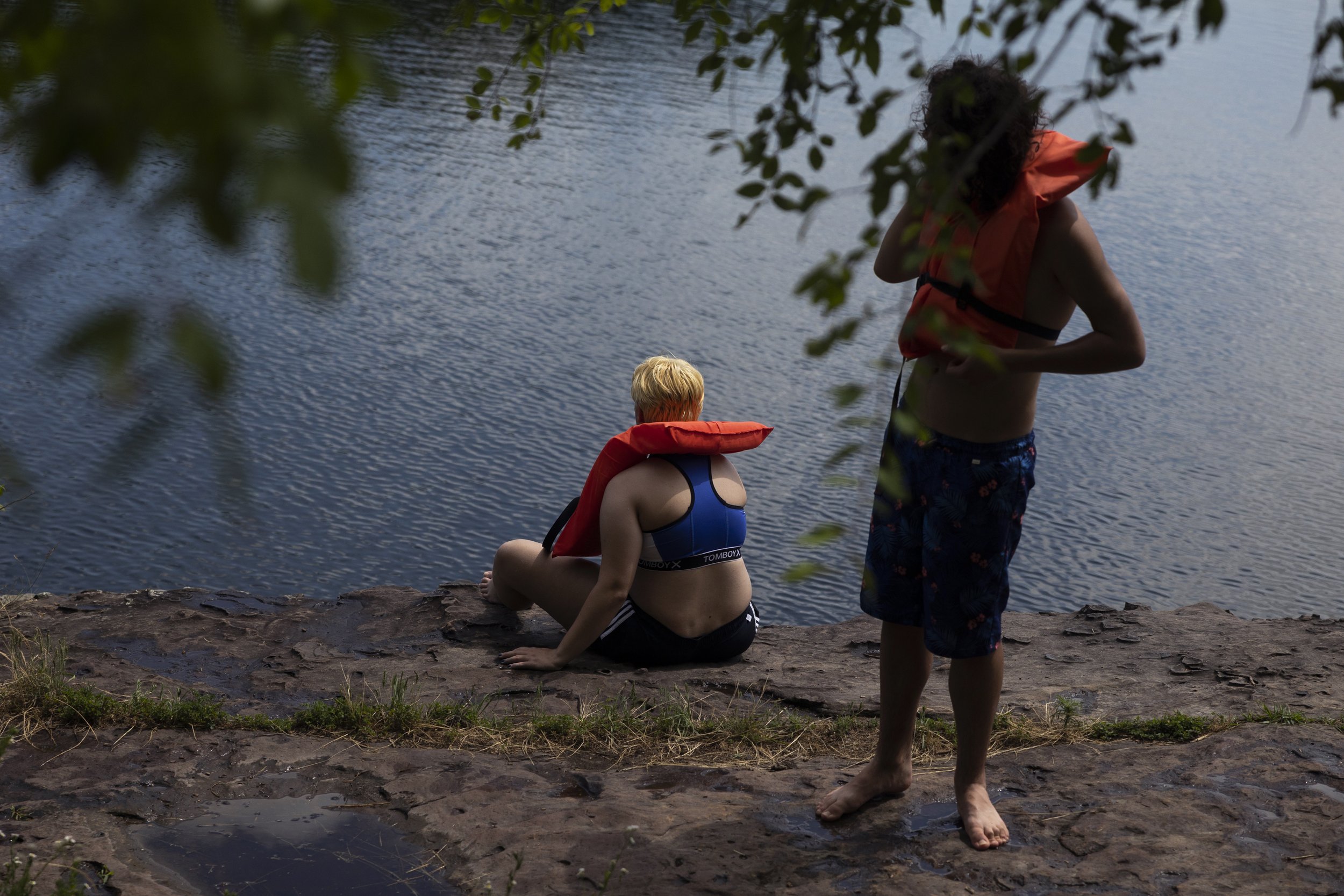  Fern (center—he/him) joins other campers in a cliff jumping activity. 