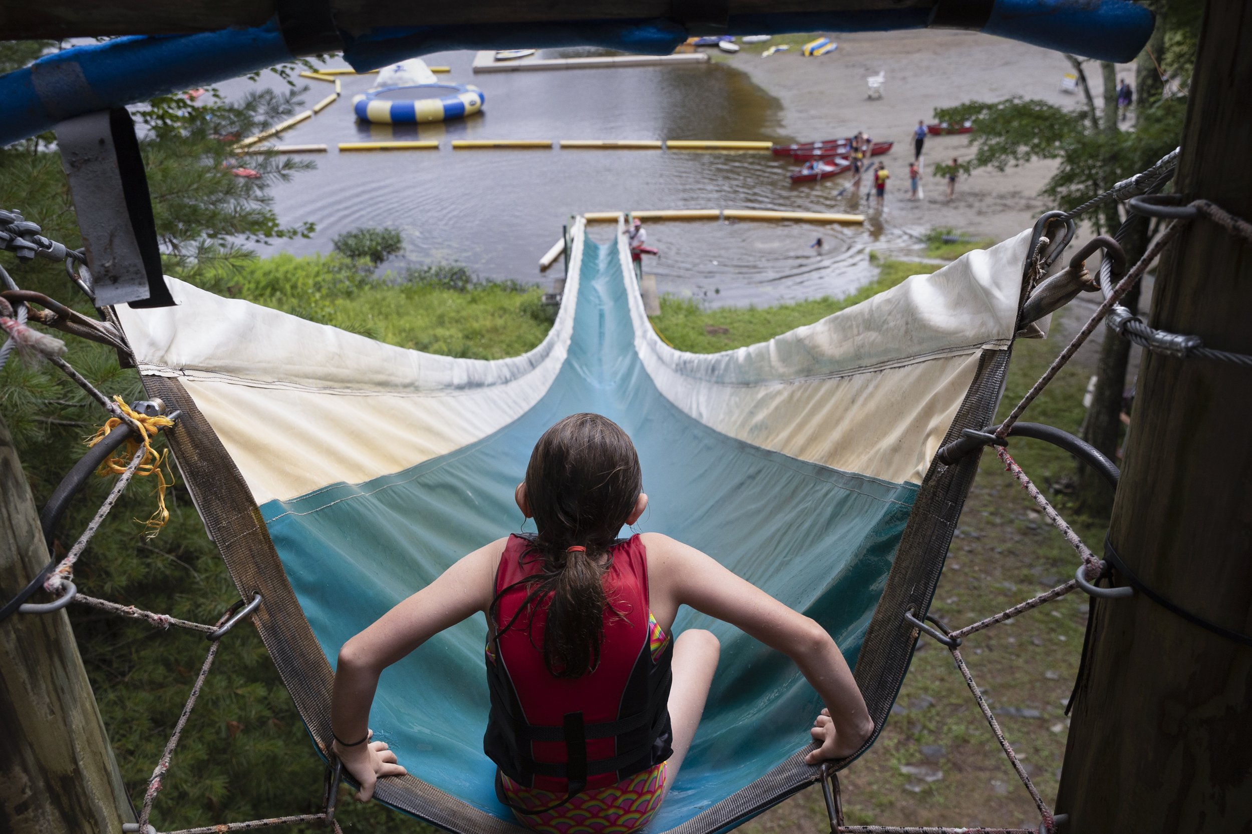  Eliza Goodman prepares to head down the water slide into Wool Lake at Camp Nah-Jee-Wah in Milford, Pennsylvania on July 9, 2021. 