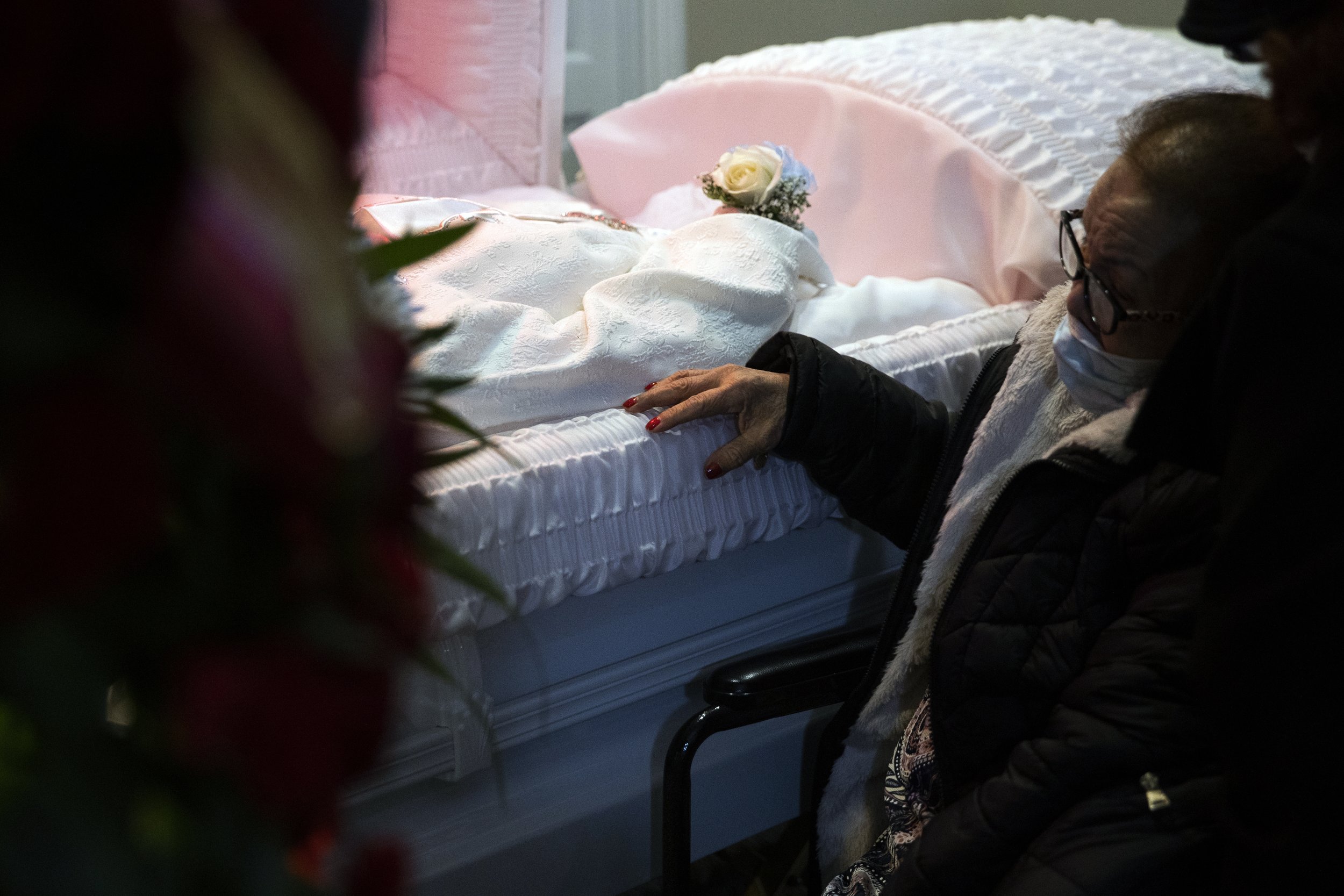  Family members pay their respects to Mildred Perry, who died from COVID-19 on February 15 at 94 years old, at Alfonso Cannon Funeral Chapel in Philadelphia on February 23, 2021. (On assignment for the New York Times)  