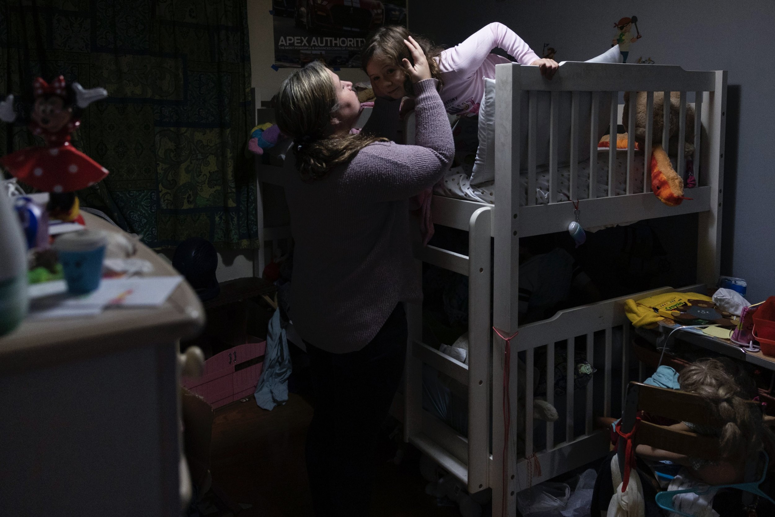  Jennifer Simpkins says goodnight to her daughter Evelyn Simpkins, 10, at their home in Downingtown, Pennsylvania on October 27, 2021. (On assignment for New York Times) 