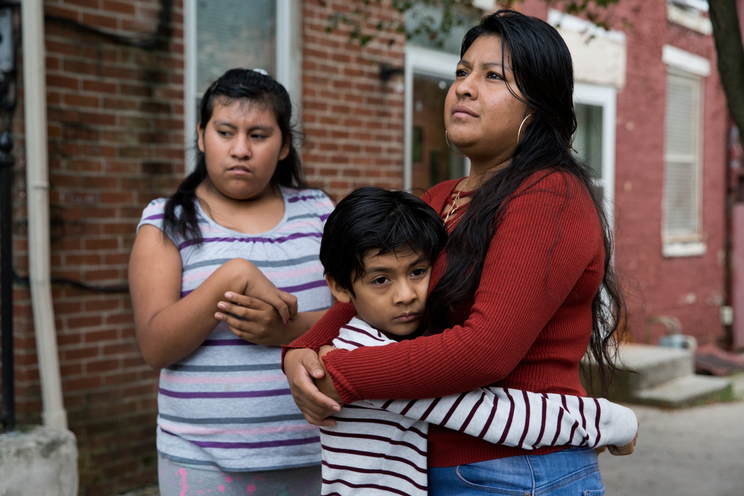  Belén Cruz stands with her children Natalie, 12, and Carlos, 8, outside of their home in York, Pennsylvania on September 18, 2020. Natalie has had trouble logging in to her school's online learning platform, and Carlos has not yet received a laptop 
